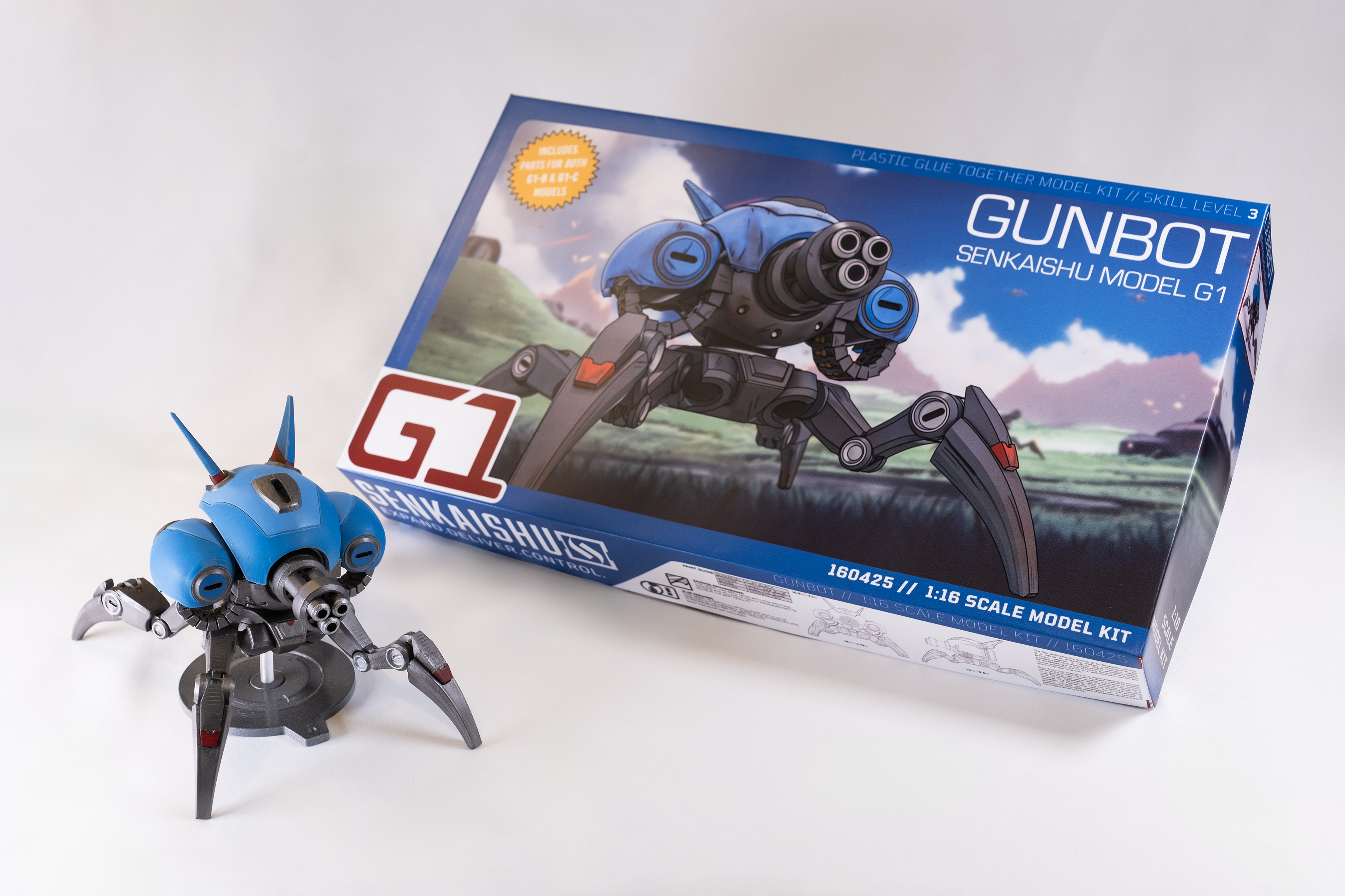 Image of a scale model of a Gunbot and its box against a white void