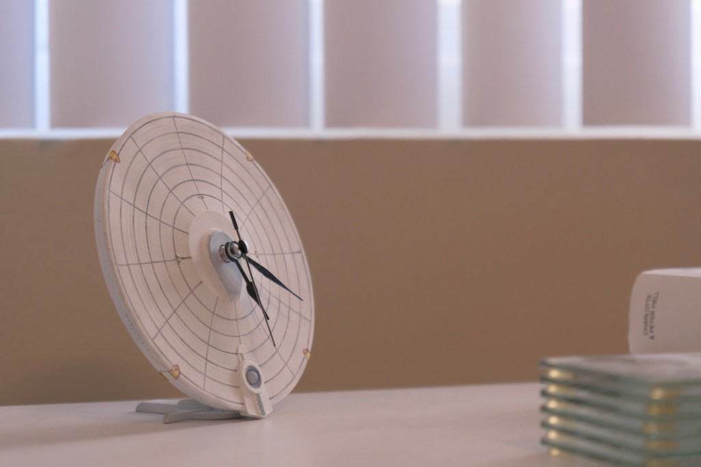 Image of a 3D printed clock made from the saucer of a Constitution class starship